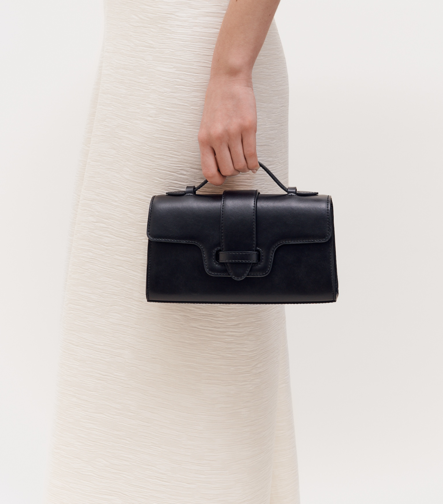 MIRUM bag luxury vegan bags best sustainable handbags savette pochette symmetry pochette savette pochette kelly pochette top handle bag 2025 it bags Stella mccartney ryderbag themoire the moire ethical luxury Spanish handbag brands Spanish bags black mini bag clutch black bag black bags small black bag clutch
